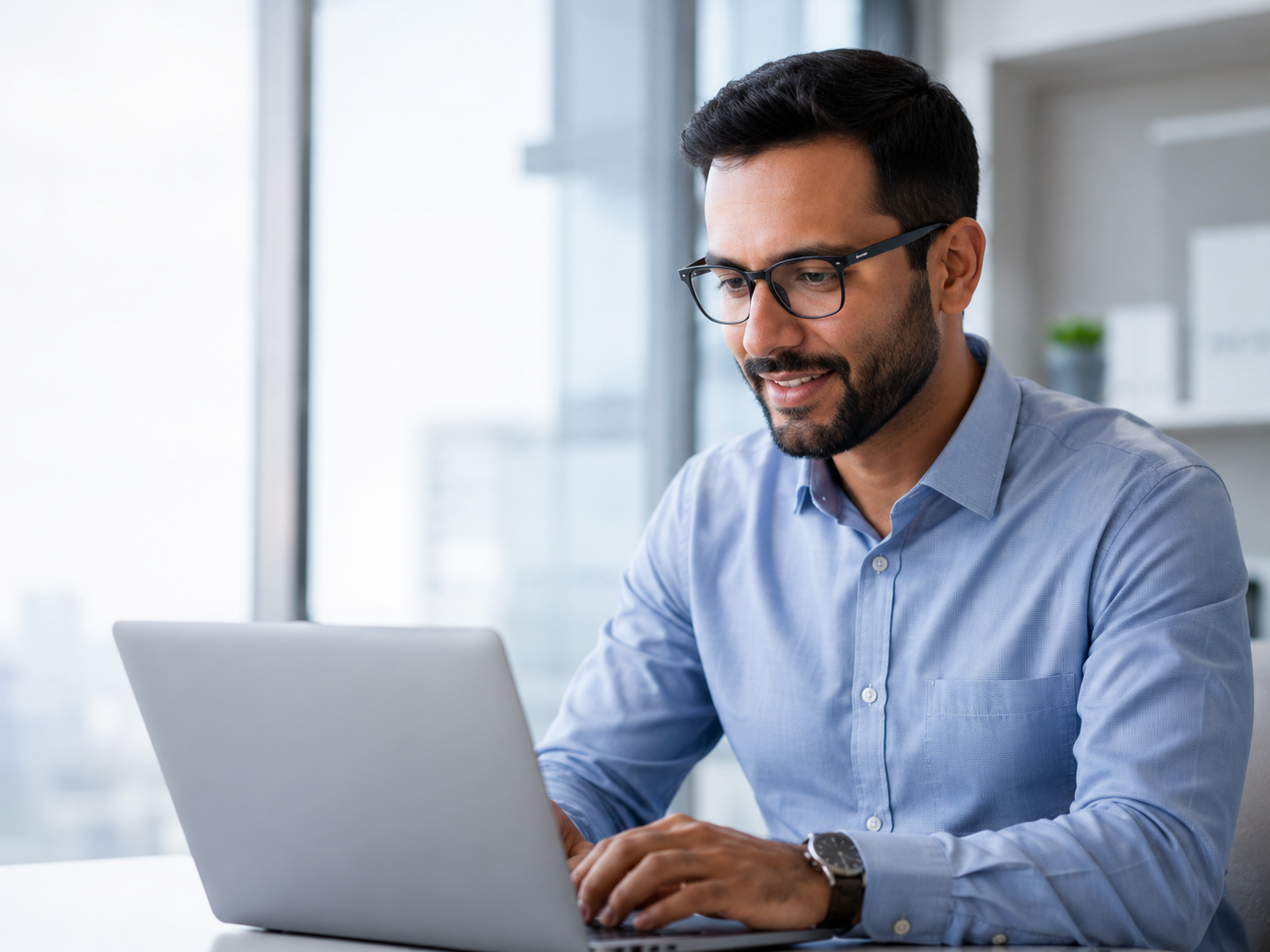 Finance professional reviewing reports on a laptop